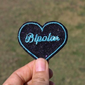 バイポーラ ブローチ ハート生地 黒 紫 青 スパンコール刺繍 青 緑 アブサン糸 メッセージは英語で刺繍されています フランス製