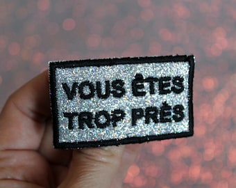 YOU ARE TOO CLOSE brooch silver fabric sparkling rainbow sequins embroidered message in French black outline made in France