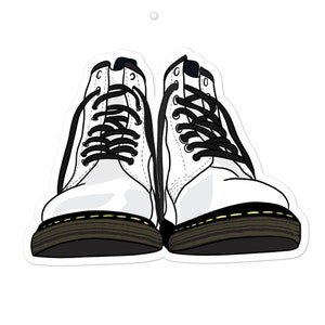 May include: A pair of white leather boots with black laces and yellow stitching. The boots have a thick black sole.