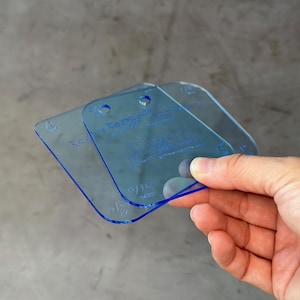 May include: Two clear blue plastic quilting rulers with measurements in inches and fractions of an inch. The rulers are labeled "The Easy Angle Ruler" and "The Easy Angle Ruler - Quilting Supplies".