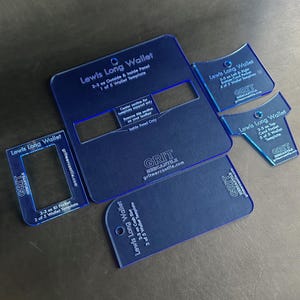 May include: Five blue plastic templates for making a long wallet. The templates are labeled "Lewis Long Wallet" and include instructions for making the wallet. The templates are for a 2-3 inch ID pocket, a cash pocket, and the outside and inside panels of the wallet.