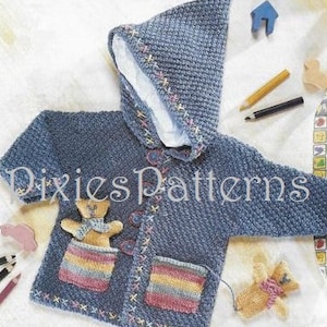 May include: A blue knitted hooded jacket with a teddy bear applique and two pockets. The pockets have colourful stripes and the jacket has a white lining.