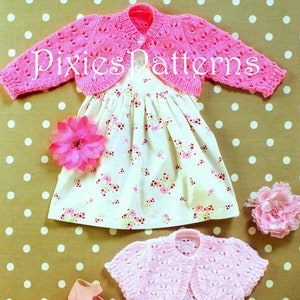 May include: A pink knitted baby cardigan with a matching dress featuring a floral pattern. The image also includes a smaller pink cardigan and a pair of pink shoes. The text "Pixies Patterns" is visible on the image.