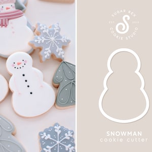 May include: A white snowman cookie cutter with a rounded shape and three tiers. The cutter is on a light brown background with the text "SNOWMAN cookie cutter" below it. The text "SUGAR REX COOKIE STUDIO EST 2015" is in a circle at the top of the background.