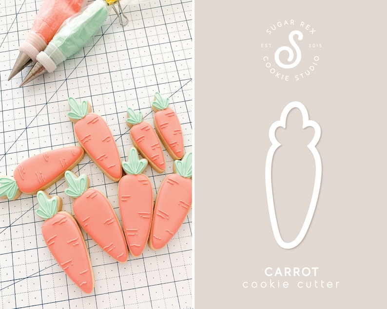 May include: A set of ten orange carrot-shaped sugar cookies decorated with green leaves and white lines. The cookies are arranged on a white gridded surface. A cookie cutter in the shape of a carrot is shown on the right side of the image. The text "CARROT cookie cutter" is below the cookie cutter. The text "SUGAR REX COOKIE STUDIO EST 2015" is in a circle above the cookie cutter.