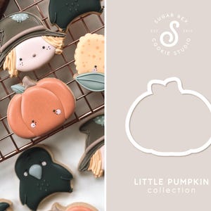 May include: A set of cookie cutters featuring a pumpkin, scarecrow, and other fall-themed designs. The cutters are made of white metal and are designed for use with cookie dough. The text "LITTLE PUMPKIN collection" is printed below the cutters.