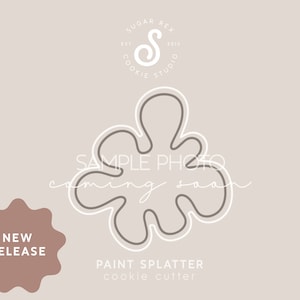 May include: A white outline of a paint splatter cookie cutter on a light brown background. The text "PAINT SPLATTER cookie cutter" is below the image. The text "NEW RELEASE" is in a pink starburst shape in the lower left corner.