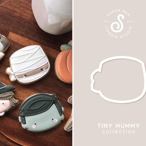 May include: A set of cookie cutters for Halloween themed cookies. The cutters are in the shape of a mummy, a ghost, a witch, a pumpkin, and a monster. The cutters are made of white plastic and are designed to be used with cookie dough.