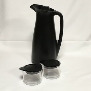 May include: A black thermal carafe with a black lid and handle, along with two clear glass cups with black lids.