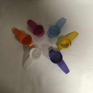 May include: Six colorful plastic funnels with mesh strainers. The funnels are in various colors, including purple, yellow, orange, white, blue, and pink.
