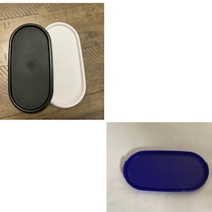 May include: Three oval-shaped plastic containers with lids. The lids are black, white, and blue.