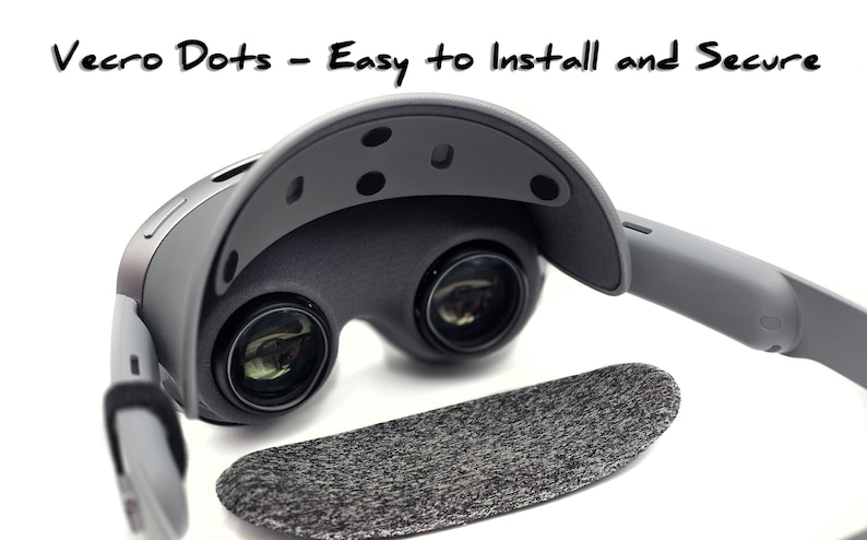 May include: A gray VR headset with the text "Vecro Dots - Easy to Install and Secure." The headset has two lenses and a dark gray foam pad. The design is modern and sleek, with a focus on ease of use.
