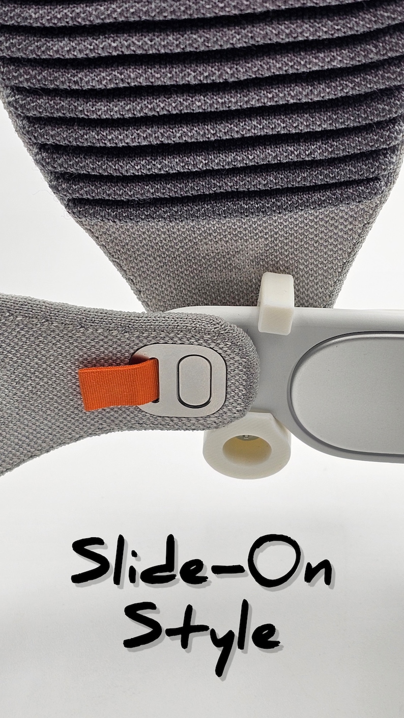 May include: A close-up of a gray and white headband with an orange strap and a silver button. The headband has a slide-on style and the text "Slide-On Style" is written below.