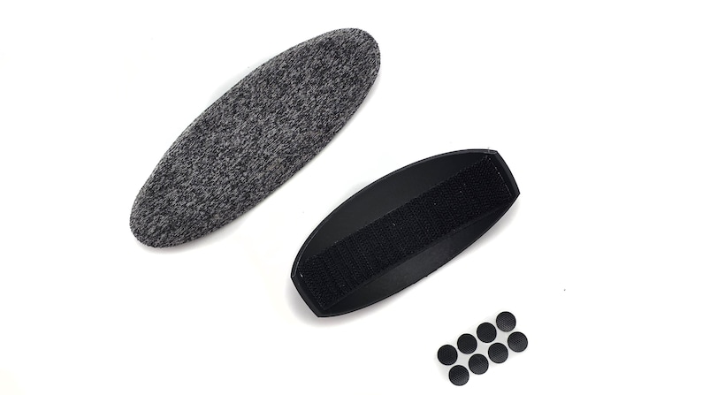 May include: An assortment of items, including a gray, oval-shaped pad, a black, curved pad with a velcro strip, and several small, black circular pads. All items are set against a white background.