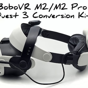 May include: A black and white VR headset with a black strap and a black and white cable. The headset has the text "BoboVR M2/M2 Pro Quest 3 Conversion Kit" written on it.