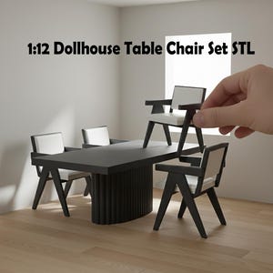May include: A miniature black table and chairs set for a dollhouse. The table has a rectangular top and a ribbed base. The chairs have black frames and white cushions. The text "1:12 Dollhouse Table Chair Set STL" is displayed.
