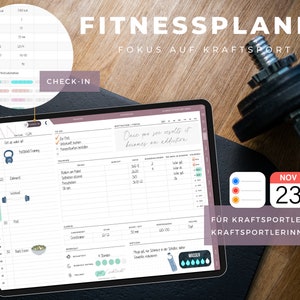 May include: A digital planner with a pink and gray cover, open to a page titled "Fitness Planner: Fokus auf Kraftsport". The page features a calendar, workout tracking, and meal planning sections. The planner is on a wooden surface with a dumbbell and a calendar with the date "Nov 23" visible.