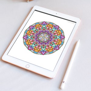 May include: A digital tablet displaying a colorful mandala design with intricate details. The tablet is white with a silver frame and is lying flat on a white surface. A white stylus is lying next to the tablet.