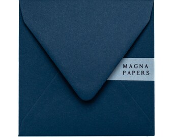 May include: A dark blue envelope with a white label that says "MAGNA PAPERS".