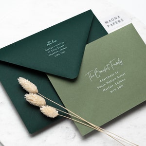 May include: Two envelopes, one dark green and one light green, with white text. The dark green envelope has the text "with love" and an address. The light green envelope has the text "The Beaufort Family" and an address.