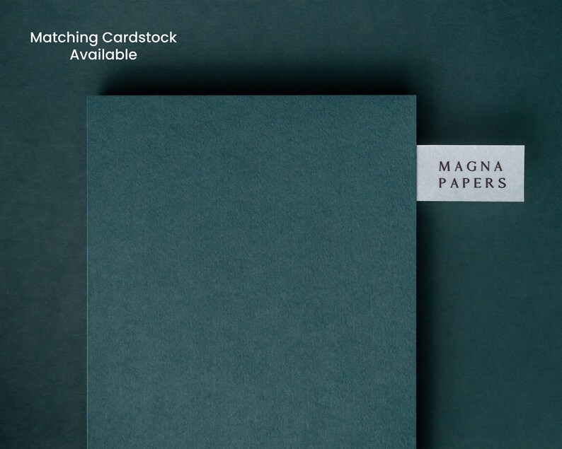 May include: A dark teal cardstock sample with the text "MAGNA PAPERS" printed on a white label.