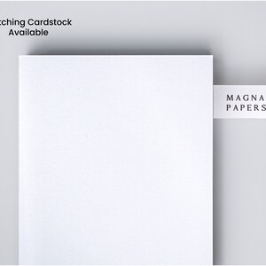 May include: A white sheet of paper with a small white label that says "MAGNA PAPERS" on it.