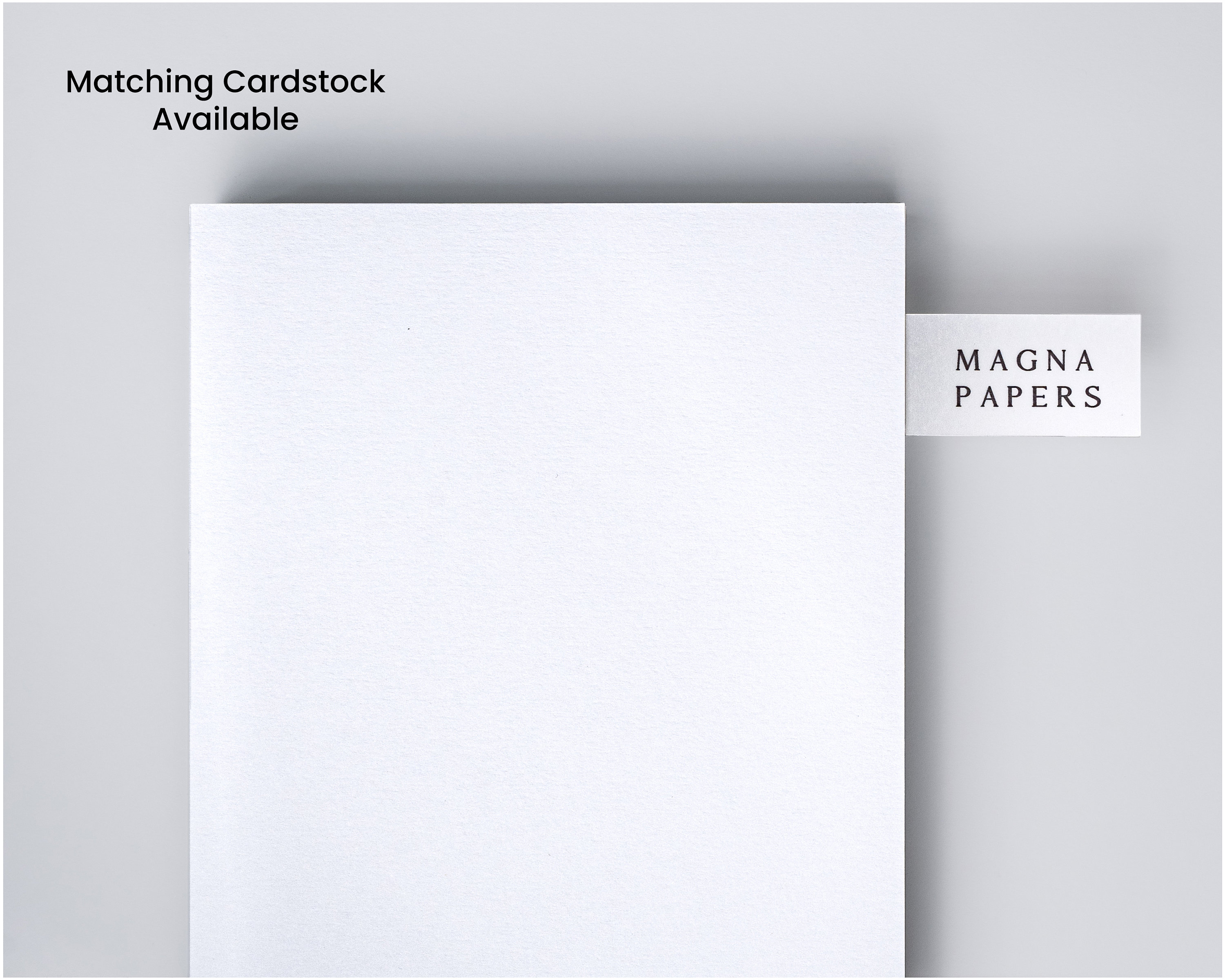 May include: A white sheet of paper with a small white label that says "MAGNA PAPERS" on it.