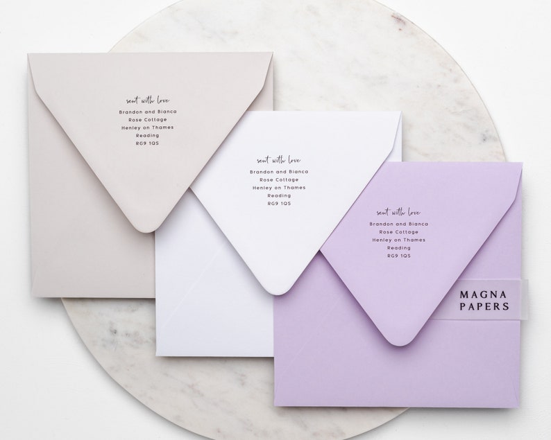 May include: Three square envelopes in different colours: light beige, white, and light purple. Each envelope has the same text printed on the front: "sent with love" followed by an address. The text "MAGNA PAPERS" is printed on a clear sticker on the purple envelope.