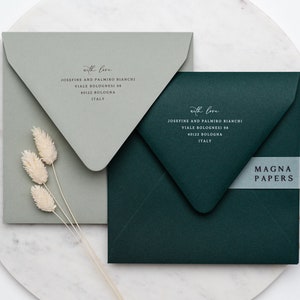 May include: Two envelopes, one green and one gray, with the text "with love" and an address printed on each. The green envelope has a white label with the text "MAGNA PAPERS" on it.