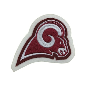 May include: A white and maroon embroidered patch featuring a ram's head with a white curled horn.