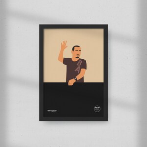 May include: Framed art print featuring a stylized illustration of a person waving. The person is wearing a brown t-shirt with the letters "BA" on it. The artwork is set against a beige background with a black lower section. The text "Afrojack" is at the bottom.
