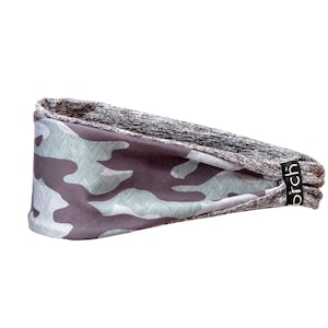 May include: A gray and green camouflage headband with a gray and white chevron pattern on the inside. The headband has the word "birch" printed on the side.