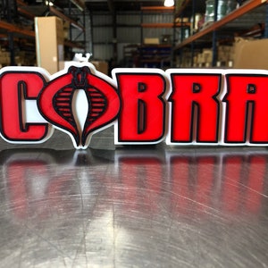 V2 Cobra logo shelf display