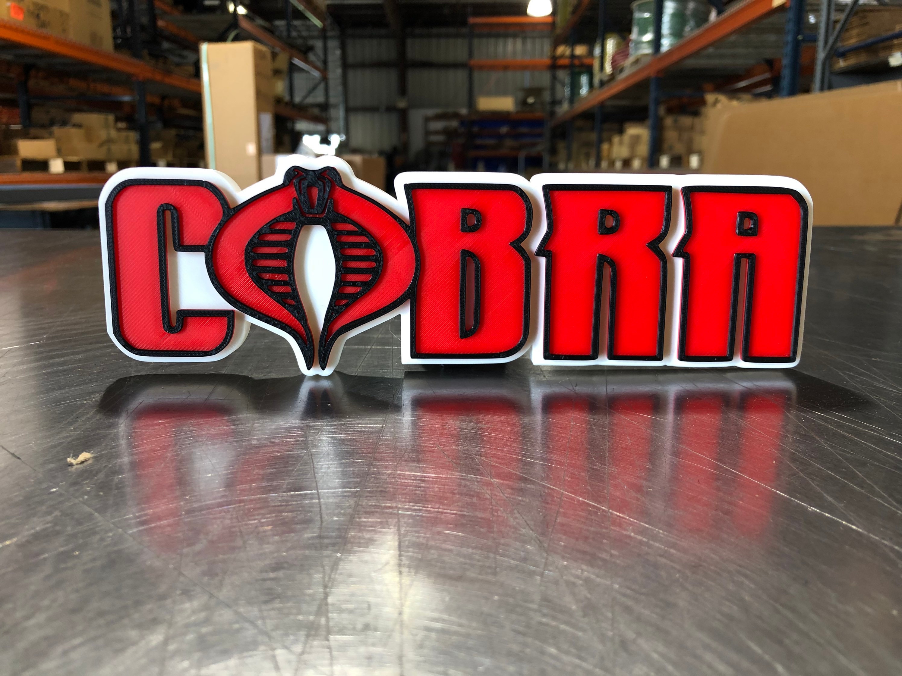 V2 Cobra logo shelf display