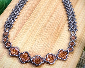 May include: A silver beaded necklace with a delicate chain and a center piece of brown faceted beads.