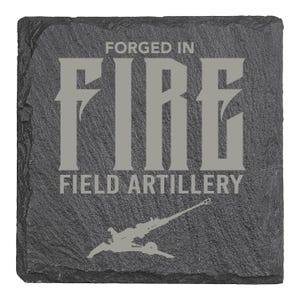 May include: Square, dark gray slate coaster with the words "FORGED IN FIRE" and "FIELD ARTILLERY" in gray lettering. A gray artillery cannon graphic is at the bottom. The coaster has a rough, textured surface.