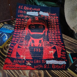 May include: A red and black poster featuring a robot illustration. The poster reads "G.I. Robot would like to count with you." and "Would you like to with G.I. Robot?"