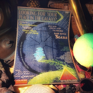 May include: A vintage poster with a blue and green star chart design. The poster reads "Looking for your place in the galaxy?" and "Join our crew and venture past the stars".