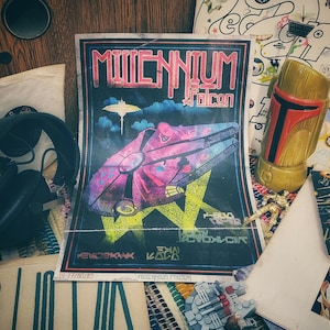 May include: A vintage poster advertising a Millennium Falcon event with a black background and colorful graphics. The poster features the text "Millennium Falcon" and the words "Hendrik Havik" and "Ewan Kates" in white. The poster is surrounded by other Star Wars memorabilia, including a book titled "Star Wars" and a Boba Fett figurine.