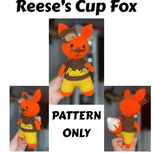 May include: Crocheted fox toy in orange, brown, and yellow, with the text "Reese's Cup Fox" above the image. The fox has a bow, a brown shirt with "Reese's" on it, and yellow shorts. The text "PATTERN ONLY" is also visible.