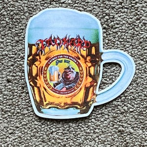 May include: A sticker in the shape of a beer mug with the words "Too Hard" in red, stylized lettering. The mug design includes a central emblem with a cartoon character and the text "Hymns for the Drunk".