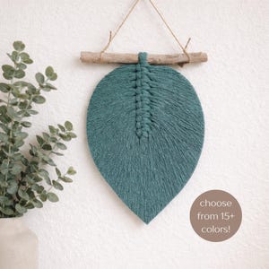 May include: A set of three ceramic mugs with a speckled, matte finish. The mugs are in shades of cream, light gray, and dark gray. Each mug has a simple, minimalist design and a rounded handle.