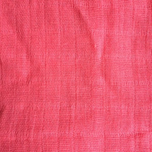 May include: A close-up of a pink fabric with a woven texture. The fabric has a slightly wrinkled appearance.