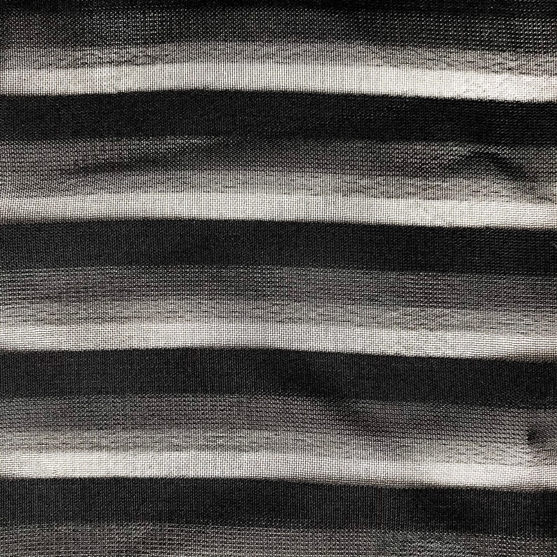 May include: Abstract black and white striped pattern with a textured, brushstroke effect.