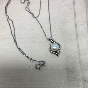 Vintage Pearl and faux diamond pendant set in solid silver with silver chain .