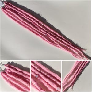 May include: Pink synthetic dreadlocks with iridescent glitter accents. The dreadlocks are arranged in a bundle and are ready to be installed.