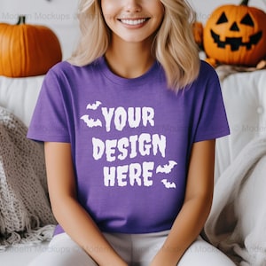 May include: A purple t-shirt with short sleeves and a white graphic that says "YOUR DESIGN HERE" with bats around the text.