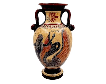 May include: A ceramic Greek amphora with a black and red design depicting a woman with wings and the word "ZEYS" on the side.