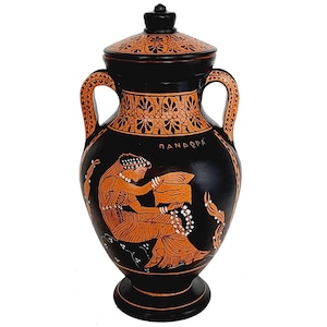 May include: Black and orange Greek amphora with a lid. The amphora features a painted scene of a woman holding a scroll. The inscription on the amphora reads "DANDOPE".