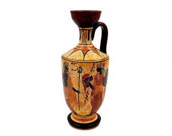 May include: A ceramic vase with a brown handle and a yellow, orange, and black painted design of three figures. The figures are painted in a black silhouette style with red and orange accents.